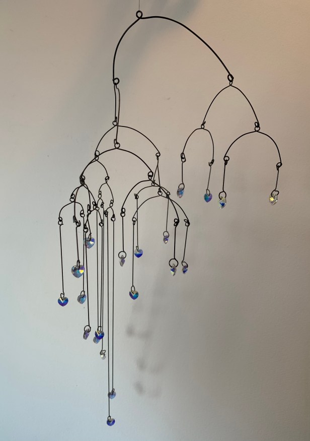 sparkly crystals hanging from wire as a mobile